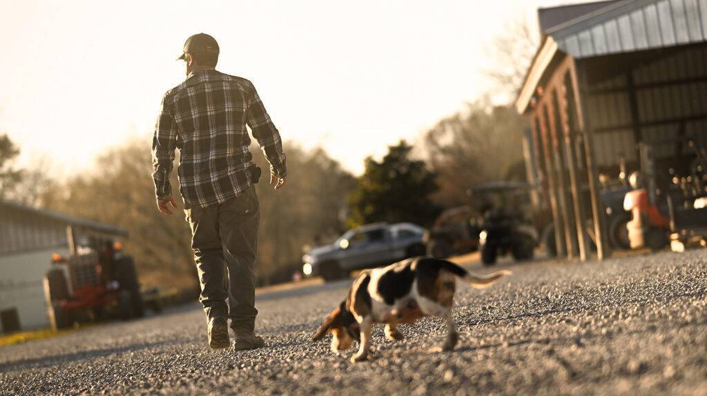 man walking with dog at the farmgate